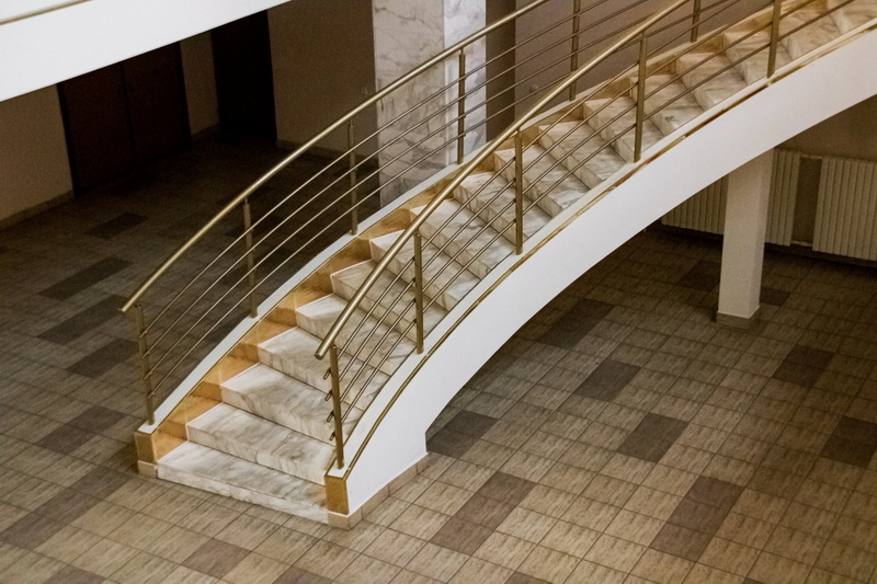 Luxurious golden round staircase indoors, top view, modern interior